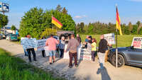 Türkheim, Deutschland – 08.05.2026: Demonstrierende protestieren mit Plakaten und deutschen Flaggen für politische Veränderungen und kritisieren Friedrich Merz.